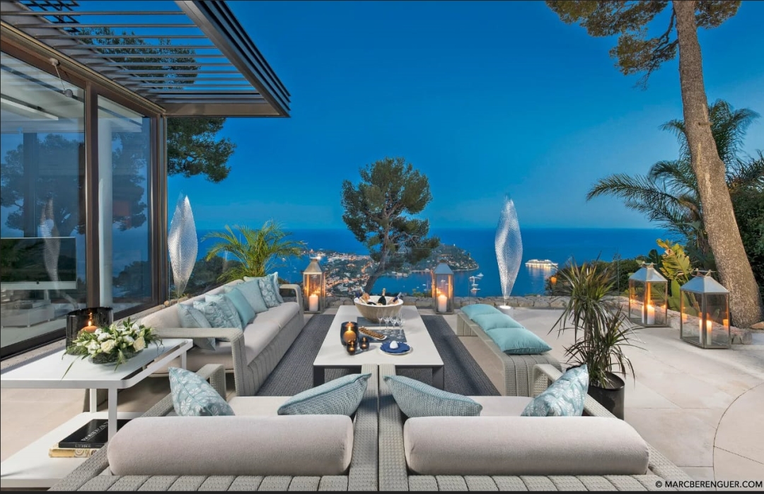Luxury villa terrace with panoramic views over the French Riviera at dusk